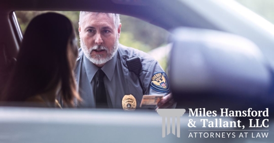 police officer talking to female driver and holding her ID