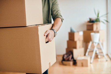 man carrying moving boxes